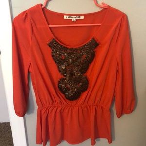 Orange top with beads on the front